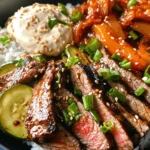 Korean BBQ has taken the culinary world by storm, celebrated for its interactive dining experience and robust flavors. This style of cooking allows diners to grill their meats, creating an enjoyable atmosphere that brings friends and family together. One dish that embodies the essence of this beloved cuisine is the Sizzling Korean BBQ Steak Rice Bowl with Spicy Cream Sauce. This dish harmoniously combines savory, tender steak, aromatic sauces, and fresh, colorful vegetables, making it a feast for both the eyes and the palate.